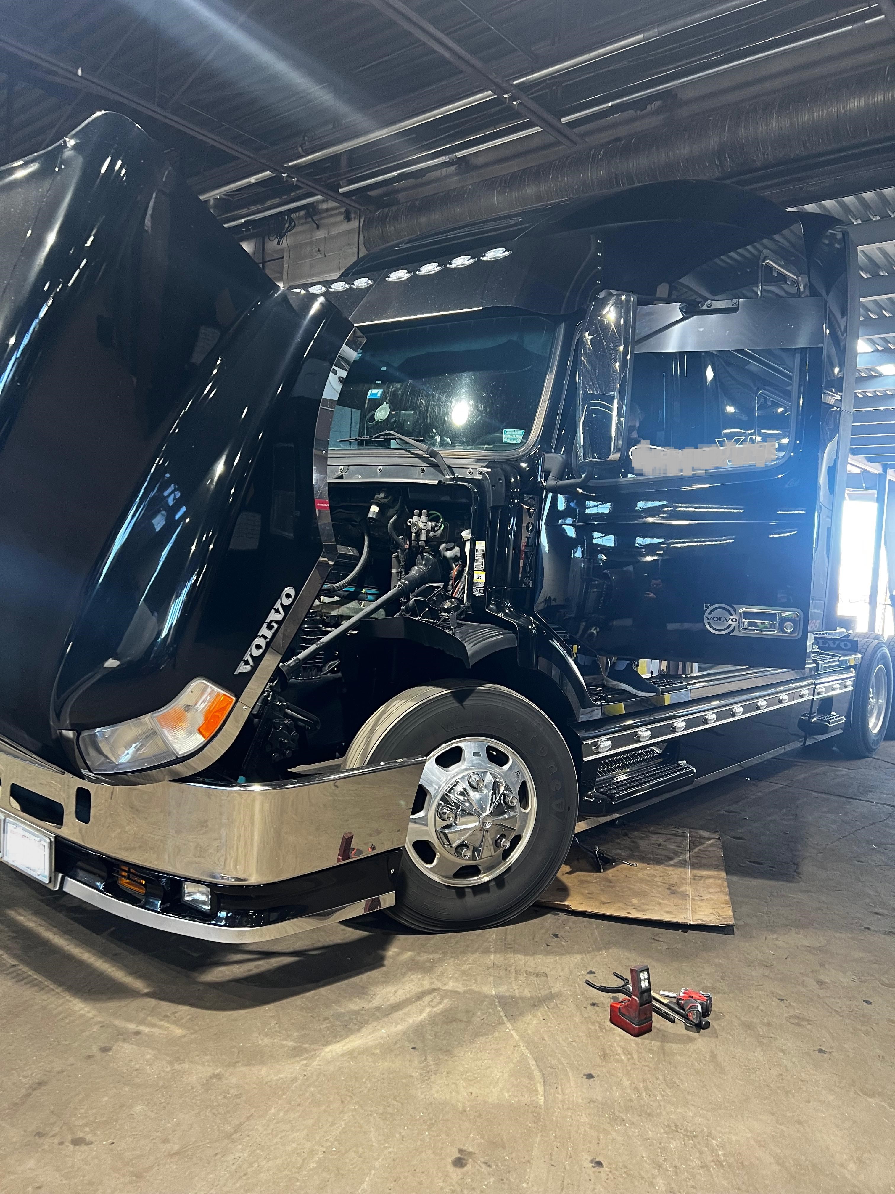 Black Volvo truck receiving service at Somet Truck Center